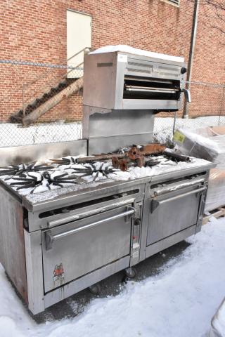 Wolf stainless steel commercial gas 10-burner range with salamander cheese melter and 2 ovens. Used condition, outdoor setting.