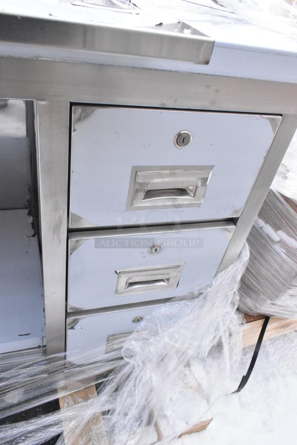 BRAND NEW Regency 600EBTB2472R 24"x72" stainless steel table, enclosed base, sliding doors, drawers, 6" backsplash, 16 gauge, slight scratches.