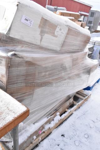 Shrink-wrapped pallet with brand new scratch and dent items including Steelton shelving units, visible labels and markings.