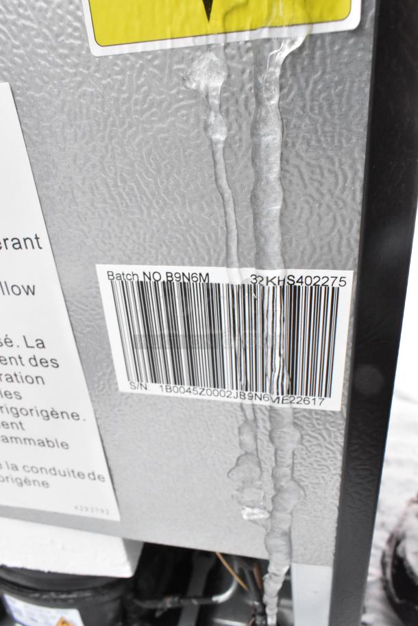 Hisense B9N6M Mini Cooler back view with barcode, batch number B9N6M, 115 volts, 1 phase. Some surface residue visible.