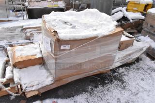 Box of 5 brand new scratch and dent items, including pop-up canopy tents and traffic door, wrapped in plastic with snow on top.