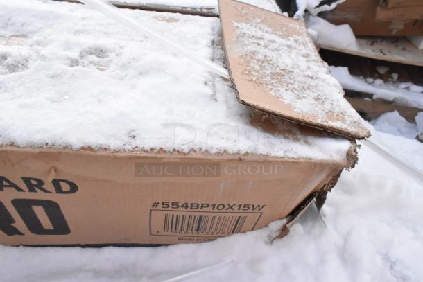 Damaged box with barcode and #554BP10X15W label, partially covered in snow, containing brand new scratch and dent items.