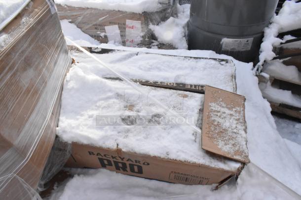 Box labeled "Backyard Pro" with snow cover, indicating scratch and dent items. Cardboard shows wear and label "#SS4BP10X15W."