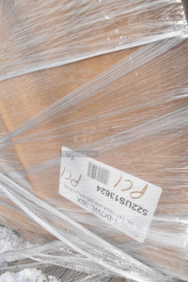 Shrink-wrapped package containing new scratch and dent items, including pop-up canopy tents and a traffic door, with visible label.