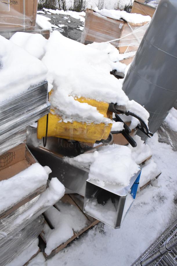 Snow-covered pallet with various items including a yellow shortening shuttle and metal table bases, in scratch and dent condition.