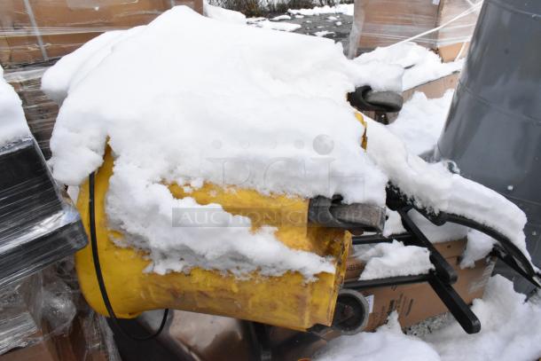 Snow-covered yellow shortening shuttle on pallet with table bases, scratch and dent condition.