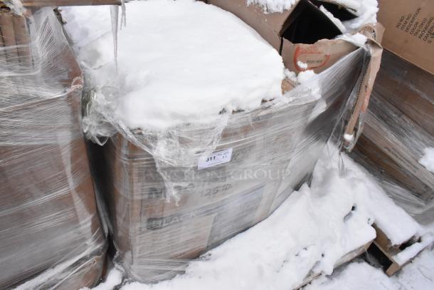 Pallet lot with wrapped items including a Choice 125 lb. black mobile ice bin. Some boxes labeled with "scratch and dent.” Snow-covered.