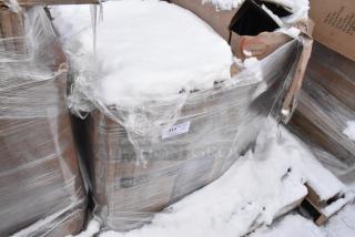 Pallet lot with wrapped items including a Choice 125 lb. black mobile ice bin. Some boxes labeled with "scratch and dent.” Snow-covered.