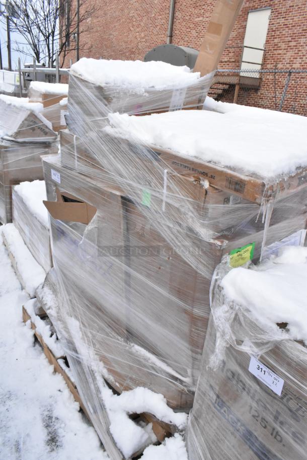Pallet lot of various items, including drying rack and chef base drawer assembly, wrapped in plastic with snow. Condition: scratch and dent. Tags visible with numbers.