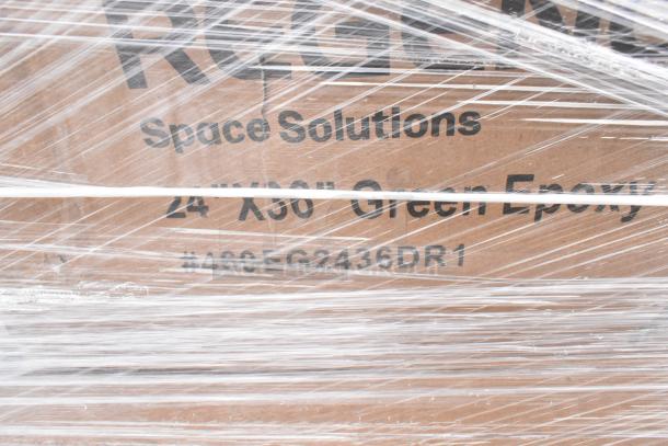 Pallet lot wrapped in clear plastic, labeled "Space Solutions 24x36 Green Epoxy #460EG2436DR1." Contains mixed items.