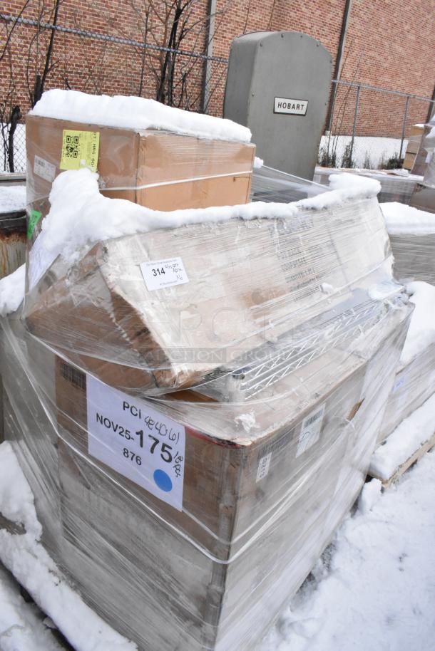 Pallet lot of brand new scratch and dent items including wire shelf, locker, and pot rack, wrapped in plastic with visible labels.