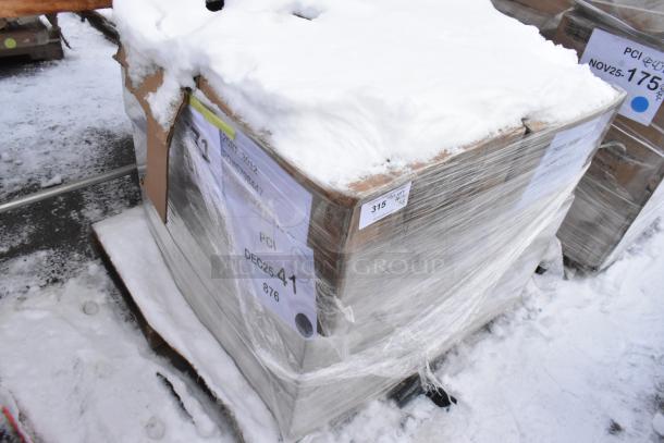 Pallet lot of brand new scratch and dent items including Metro glass racks and plates, wrapped in plastic, snow-covered. Tags visible.