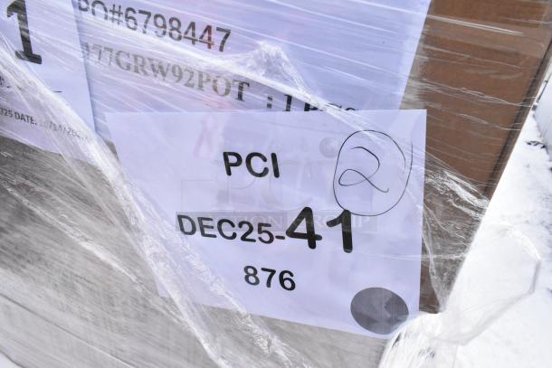 Pallet lot wrapped in plastic, labeled "PCI DEC25-41," containing various scratch and dent items like Metro glass racks and plates.