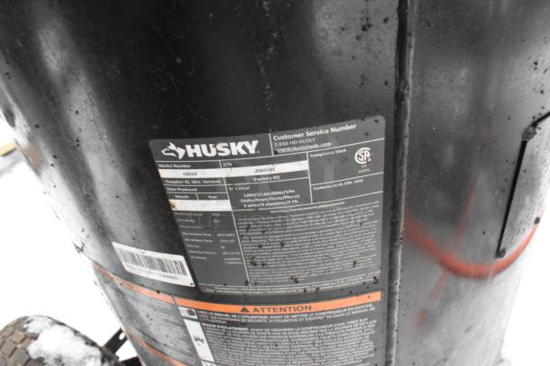 Husky C301H Air Compressor, model C301H. Features visible labels and markings indicating specifications.