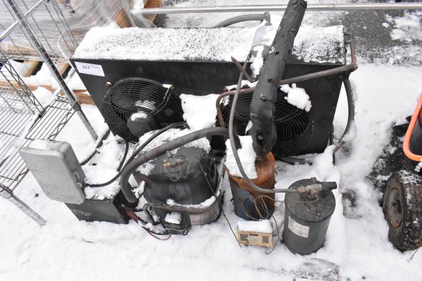 Tecumseh AV180RT Commercial Compressor with fans, snow-covered, visible label indicating model number.