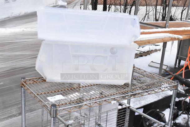 Two chrome finish wire shelving units, snow-dusted, with visible wear. Includes plastic storage boxes on top. Buyer dismantles.