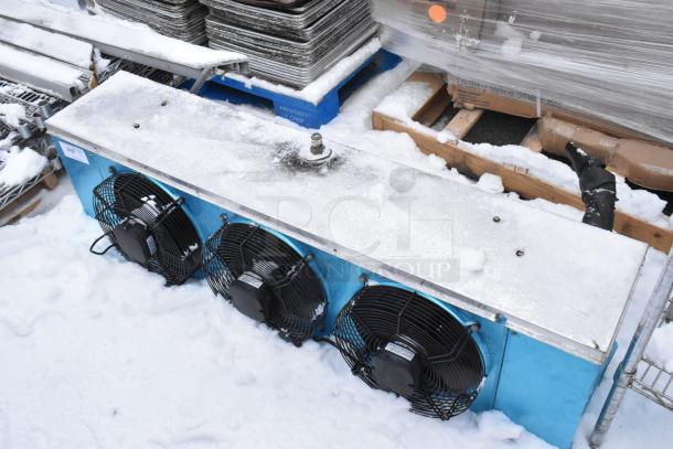 Metal commercial evaporator fan, 13,000 BTU, 220 volts, 1 phase, features three black fans, used condition, visible snow coverage.