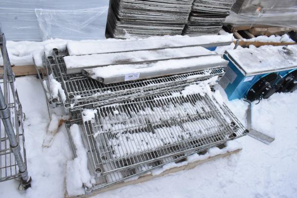 Pallet lot of wire shelves with snow, visible tag showing item number 320. Mixed sizes, metal construction. Used condition.