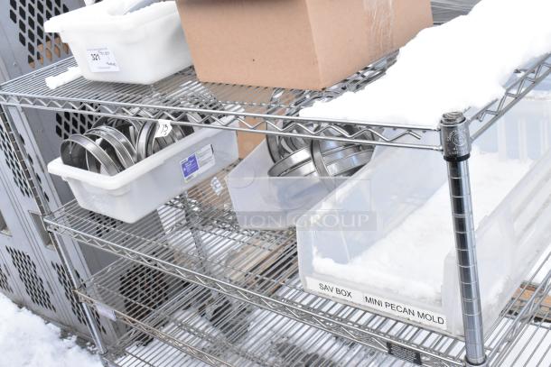 Chrome finish 4-tier wire shelving unit with various contents, plastic bins labeled "SAV BOX" and "MINI PECAN MOLD." Buyer must dismantle.