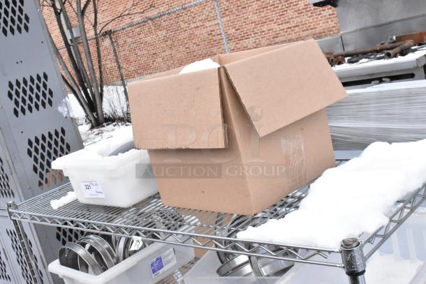 Chrome finish 4-tier wire shelving unit, includes cardboard box and plastic bins. Snow on shelving. Buyer must dismantle.