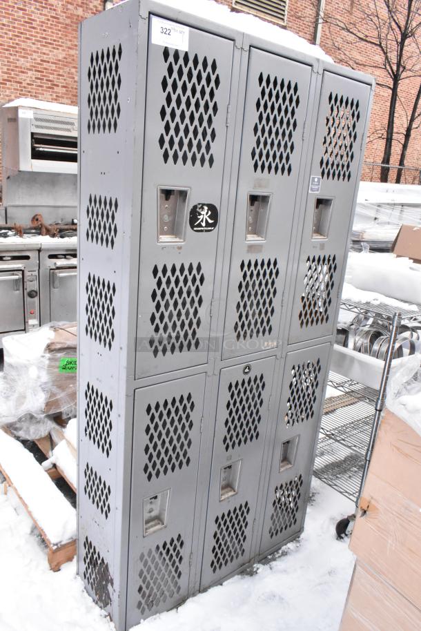 Gray metal 6 cubby locker, vented doors, used condition, with stickers and number tags visible on the front.