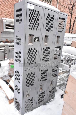 Gray metal 6 cubby locker, vented doors, used condition, with stickers and number tags visible on the front.