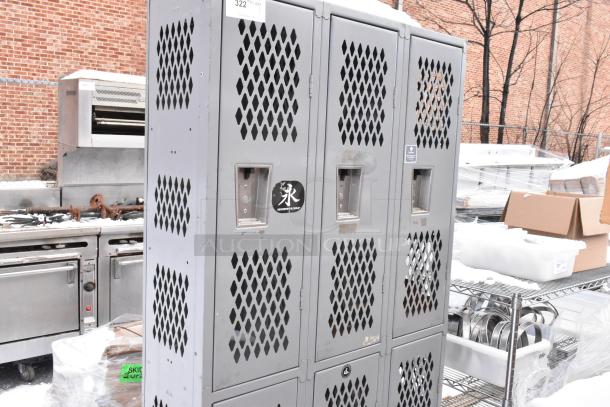 Gray metal 6 cubby locker with perforated doors, showing signs of wear. Includes label with number 322.