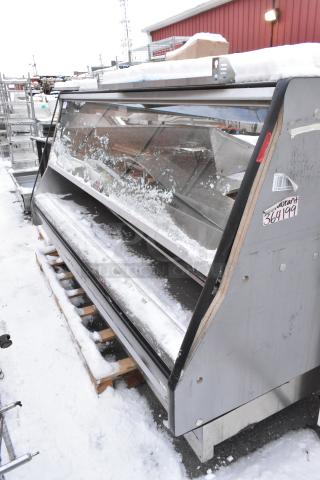 Custom Deli's Equipment metal heated display case, floor style, snow-covered, with glass front. Condition: used.