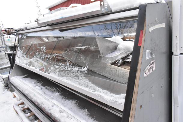 Custom Deli's Equipment heated display case, metal, floor style, snow-covered, visible label with barcode, model 368199.
