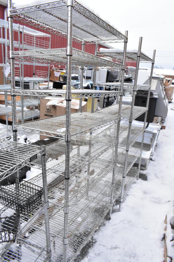 Two chrome finish wire shelves, multi-tiered, in excellent condition, suitable for storage or display, outdoor setting.