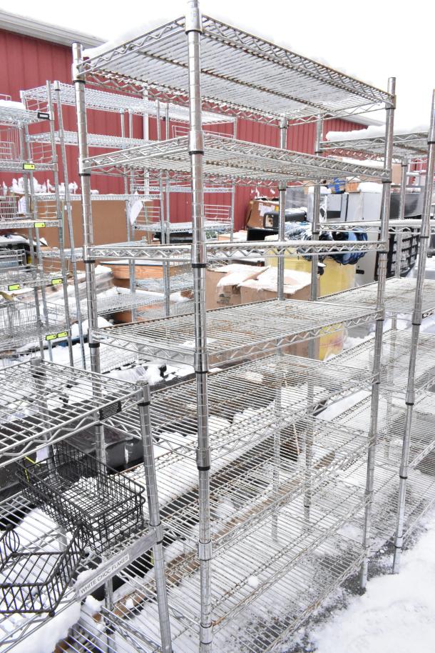 Two chrome finish wire shelves with multiple tiers, snow-covered, sturdy construction, suitable for storage or display.