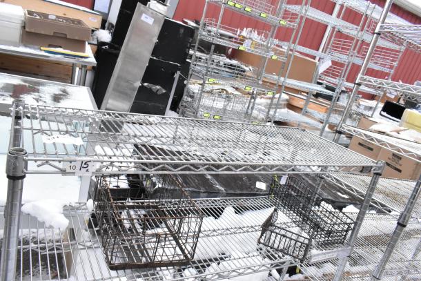 Chrome finish 3-tier wire shelf on commercial casters, in used condition. Includes tags with numbers; dismantling required for shipping.