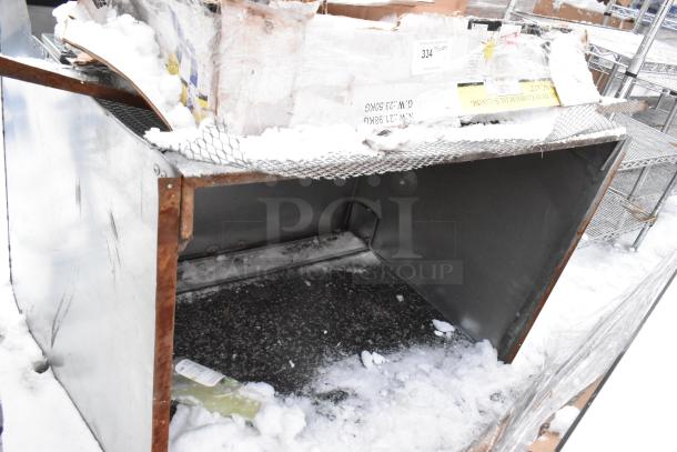 Heavy duty commercial shelving unit, metal construction, visible rust and snow, label reads "Heavy Duty Commercial Shelving."