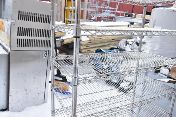 Chrome finish 8-tier wire shelving unit. Requires dismantling by buyer. Consider freight charges. Visible in outdoor setting.