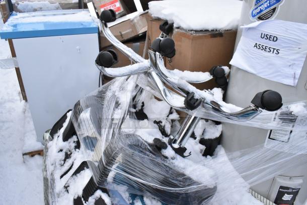 Pallet with Bradford White LD40S33B090 water heater, patio umbrellas, assorted items in snow, marked "Used Assets."