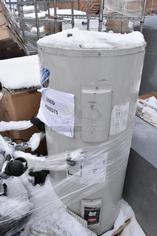 Bradford White LD40S33B090 storage water heater, used condition, with labels and protective wrap, snow-covered top.