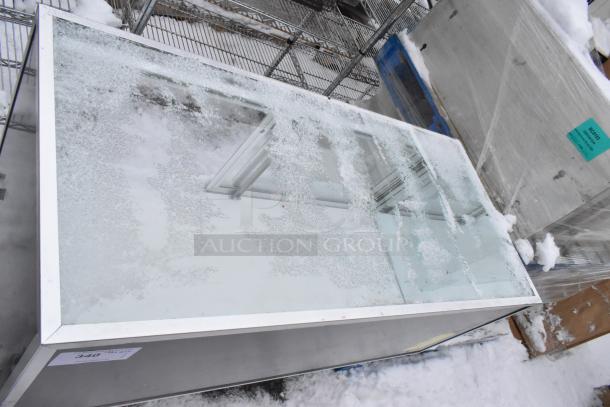Merchandise display case with glass top, frosted surface, and metal frame. Condition appears weathered with visible ice.