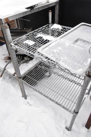 Chrome 2-tier wire shelving unit, snow-covered, rust visible, buyer must dismantle, consider freight charges.