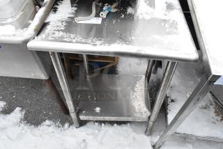 Stainless steel table with metal undershelf, used condition, snow on surface, NSF certified.