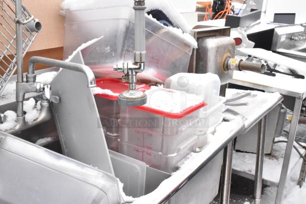 Stainless steel 3-bay sink with left side drain board, containing poly bins; good condition, suitable for commercial use.