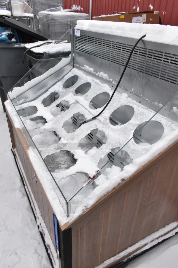 2023 Borgen Systems RR80-6957 metal merchandiser, snow-covered, 220V, glass front, 12 circular slots, wood panel sides.