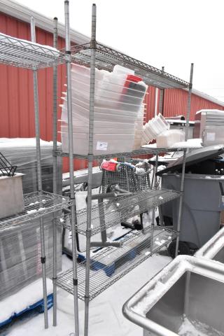 Chrome finish 4-tier wire shelving unit holding multiple poly bins. Buyer must dismantle. Consider freight charges.