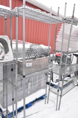 Chrome finish 2-tier wire shelving unit with a cutting board drying rack. Includes other contents. Buyer must dismantle.