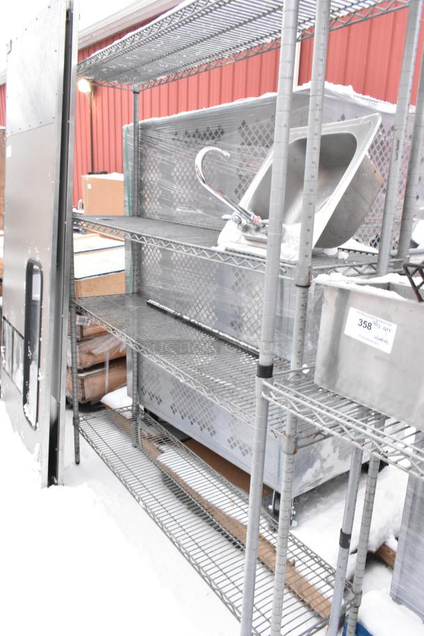 Chrome finish 4-tier wire shelving unit with attached sink, condition used. Includes contents; buyer must dismantle.