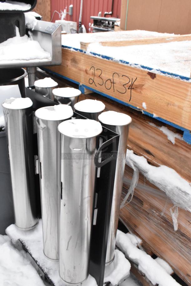 Cup dispenser dolly and gray trash can on a snowy surface, wooden crate marked "23 of 34" nearby.