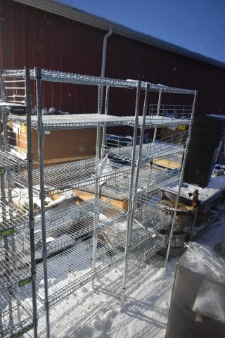 2 chrome wire shelving units, outdoor snow setting, five-tier structure, dismantling required, freight considerations advised.