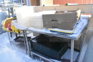 Stainless steel table with under shelf, poly bins, trash can, and glass racks. Snow-covered, outdoors. Good condition.