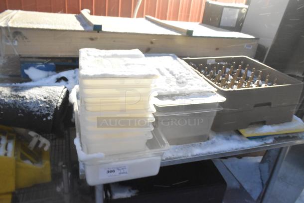 Stainless steel table with under shelf, poly bins, trash can, and glass racks. Some contents covered with snow. Item tag reads "366".