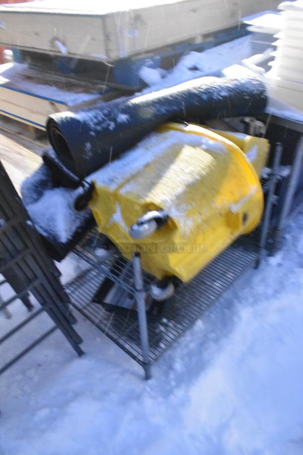 Chrome finish 2-tier wire shelving unit with yellow mop bucket and snow-covered black mat. Buyer must dismantle for shipping.