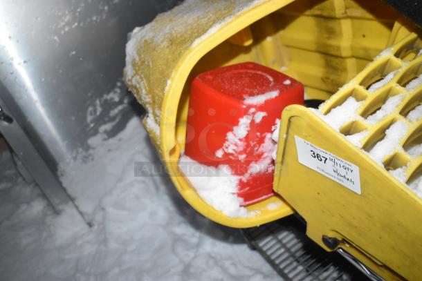 Chrome finish 2-tier wire shelving unit with mop bucket. Buyer must dismantle. Includes PCI auction label.